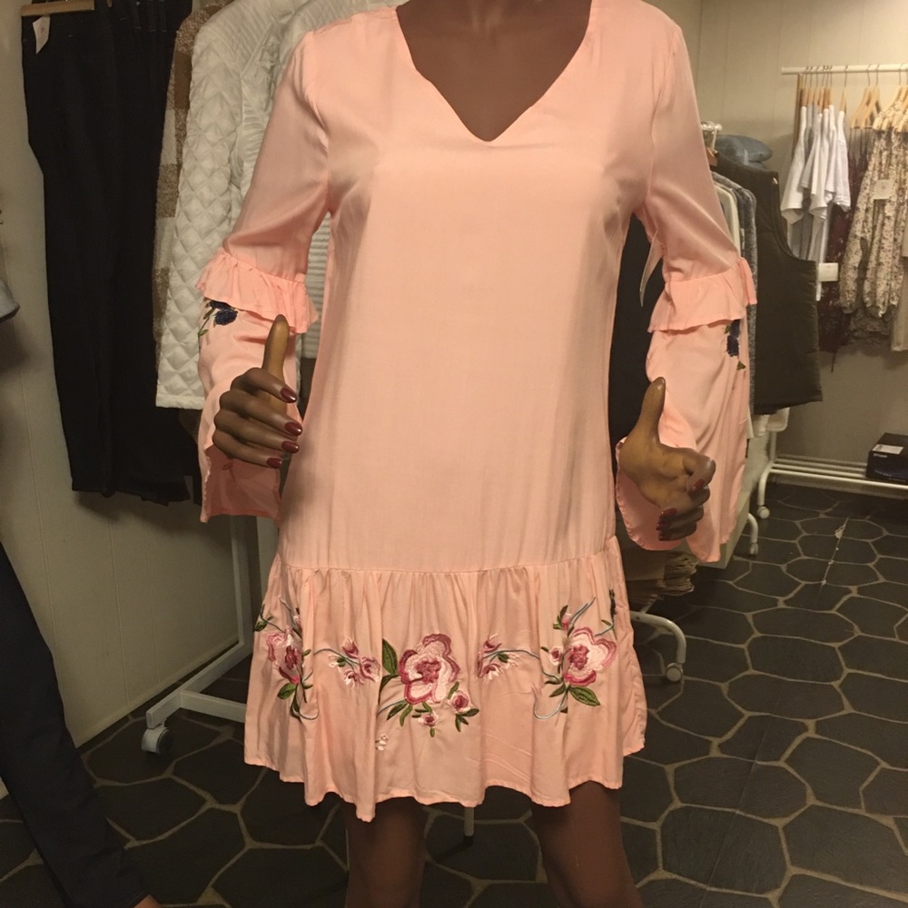 pink women’s dress with flowers detail